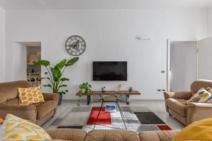 a living room with two couches and a tv at A Casa di Nonna Anna in Porto Azzurro +23 photos