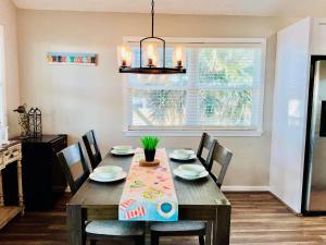 a dining room with a wooden table and chairs at Bailey Beach House Beach Views in Freeport +28 photos