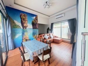 a living room with a table and a couch at Cocoloco Pool Villa Ao Nang in Ao Nang 