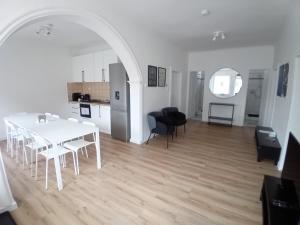 a white table and chairs in a living room at Bükfürdő Bercsényi 13 apartmanház, Bükfalva in Bük