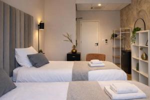 a bedroom with two beds with towels on them at Vibrant Raamsdonksveer, near Efteling & Biesbosch in Raamsdonksveer