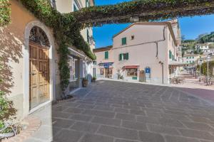a cobblestone street in a town with buildings at A Casa di Nonna Anna in Porto Azzurro