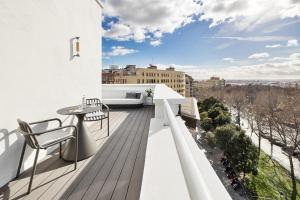 a balcony with a table and chairs on a building at One Shot La Latina in Madrid