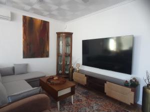 a living room with a large flat screen tv at Chalet Laguna Rosa in Torrevieja
