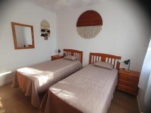 two beds sitting next to each other in a room at Chalet Laguna Rosa in Torrevieja +43 photos