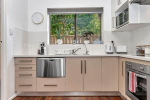 a kitchen with a sink and a window at Secure Suite in Gated Complex, Courtyard, 5 Min CBD in Rose Park +9 photos