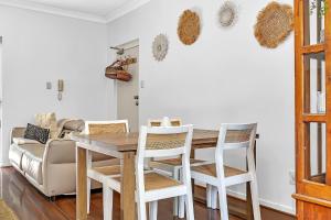 a dining room with a wooden table and chairs at Secure Suite in Gated Complex, Courtyard, 5 Min CBD in Rose Park