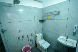 a bathroom with a toilet and a sink at Hotel The Mountmist in Kakkanad +53 photos