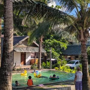 a group of children playing in a swimming pool at North Shore Surf Camp in Baler
