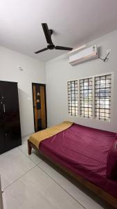 a bed in a room with a ceiling fan at sahara private villa in Cochin