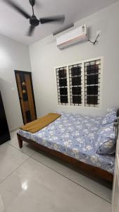 a bed in a room with a ceiling fan at sahara private villa in Cochin