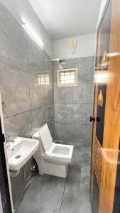 a bathroom with a white toilet and a sink at sahara private villa in Cochin