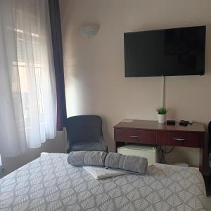 a bedroom with a bed and a desk and a television at Vila Eni in Smederevo