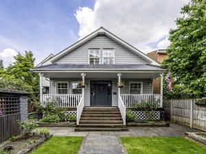 a white house with a fence at River Haven - River Thames frontage house in Thames Ditton