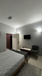 a bedroom with a bed and a desk and a chair at Vila Eni in Smederevo