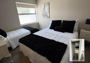 a bedroom with two beds and a window at Waterfront Retreat on the foreshore of Queen Charlotte Sound in Picton +19 photos