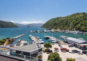 a view of a marina with boats in the water at Waterfront Retreat on the foreshore of Queen Charlotte Sound in Picton