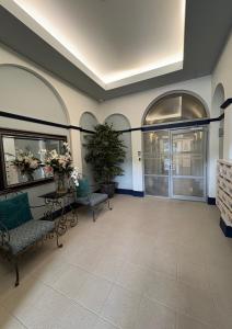 a lobby with two benches and a potted plant at Waterfront Retreat on the foreshore of Queen Charlotte Sound in Picton