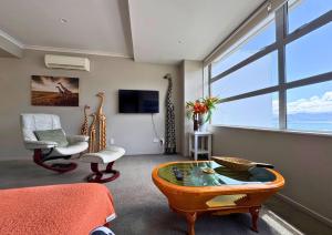 a living room with a view of the ocean at Waterfront Retreat on the foreshore of Queen Charlotte Sound in Picton