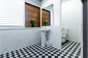 a bathroom with a sink and a toilet at Aladdin Guest House in Phi Phi Islands +46 photos