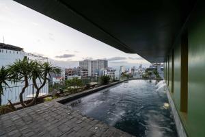 a swimming pool on the side of a building at Olwen Boutique Hotel in Danang
