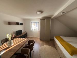 a bedroom with a bed and a table with chairs at Allgäu Residenz & Spa in Wiggensbach +3 photos