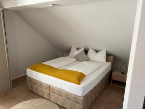 a bedroom with a bed with white sheets and pillows at Allgäu Residenz & Spa in Wiggensbach