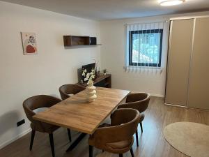 a dining room with a wooden table and chairs at Allgäu Residenz & Spa in Wiggensbach