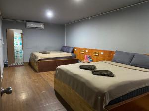 a room with two beds in a room at Aladdin Guest House in Phi Phi Islands