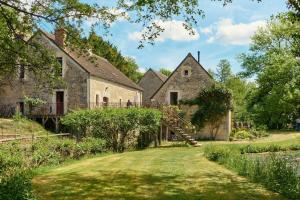 an old stone house with a staircase in the yard at Water Mill - Private Lake - Fiber Wifi - Burgundy in Rix