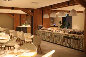 a restaurant with tables and chairs and a counter at Hotelaround Forest in Pyeongchang