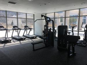 a gym with several tread machines in a room with windows at Hotelaround Forest in Pyeongchang