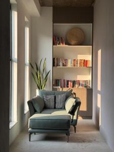 a living room with a couch and a book shelf at Calmsutra retreat in Sānkhu