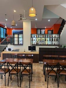 a restaurant with wooden tables and a bar at Ha Giang SkyPath Hostel & Tours in Làng Lap