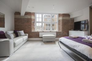 a living room with a bed and a couch at ChocoLets - The Quality Suite in York