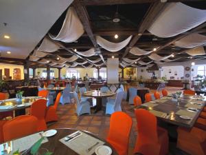 a dining room with tables and chairs and tablesktop at Marbella Place Anyer by Jayakarta in Kamasan