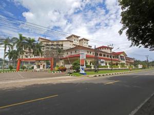 a large building on the side of a street at Marbella Place Anyer by Jayakarta in Kamasan