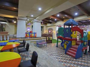 a restaurant with a play area with a playground at Marbella Place Anyer by Jayakarta in Kamasan