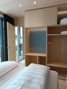 a bedroom with a large white bed and shelves at Jules - Come Together in Stuben am Arlberg