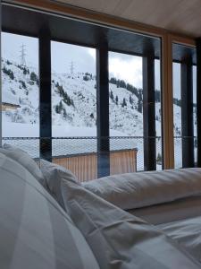 a room with a view of a snow covered mountain at Jules - Come Together in Stuben am Arlberg