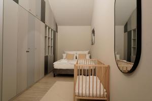 a small bedroom with a bed and a mirror at Wohnkultur - Industrial Loft Schwetzingen in Schwetzingen