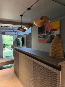 a bar in a kitchen with several pendant lights at Hostel Samui in Nathon Bay +14 photos