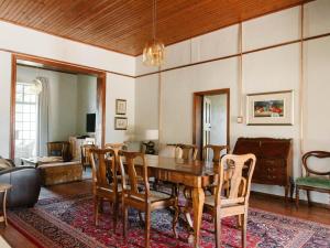 a living room with a wooden table and chairs at Kokerboom House in Vanrhynsdorp