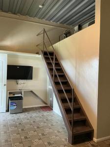 a staircase in a room with a tv at Serenity Busay Room 5 in Cebu City