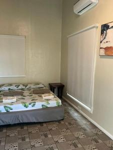 a small bedroom with a bed and a window at Serenity Busay Room 5 in Cebu City