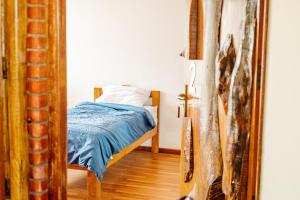 a bedroom with a bed with a blue blanket at Ethico Retreat Formely Five14 BnB in Pātan