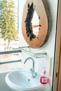 a bathroom with a mirror on the wall above a sink at Ethico Retreat Formely Five14 BnB in Pātan