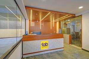 a fast food restaurant with a reception counter at FabHotel SRP in Hyderabad