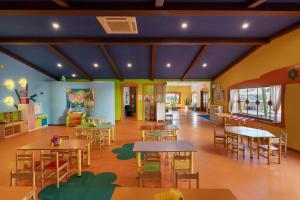 a classroom with tables and chairs in a school cafeteria at Limak Limra Hotel & Resort Kemer - Kids Concept in Kemer