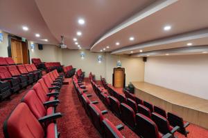a lecture room with red chairs and a podium at Limak Limra Hotel & Resort Kemer - Kids Concept in Kemer +112 photos
